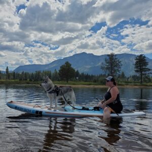 Heather and her dog Timber on a paddleboard